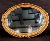 152 - Oval mirror in gold gilt decorative frame, 25 x 21