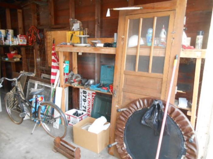 vintage exterior door, vintage bicycle, power hand tools , rebounder in the garage