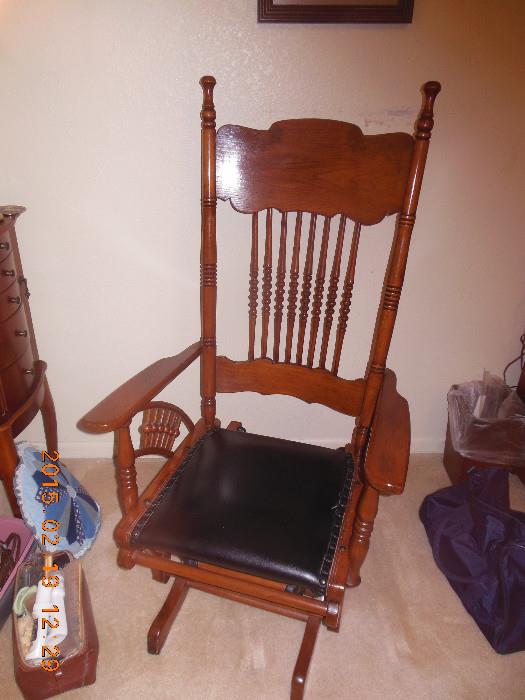 Wooden spindle glider/ rocker with leather seat. 