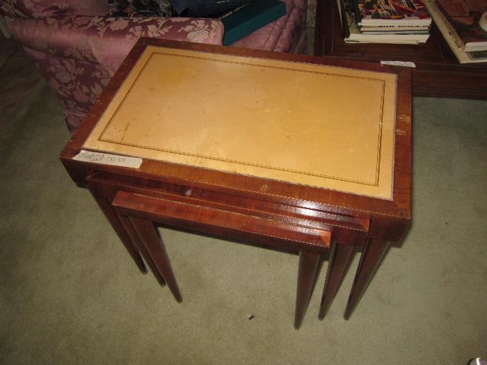 A set of 3 nesting tables, leatherette-topped, and very cool.