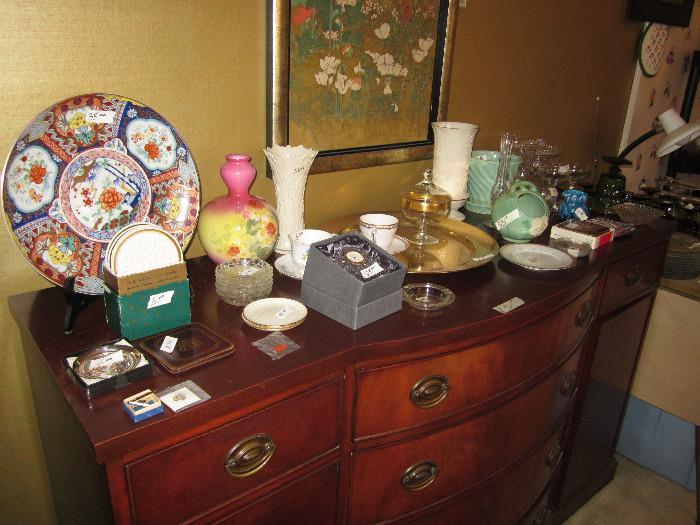 Drexel chest in the dining room with pottery, small Waterford clock, vases and misc.