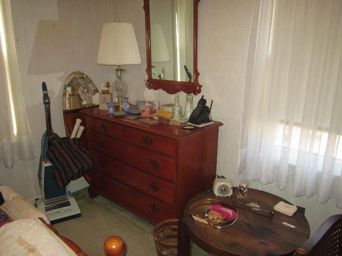 dresser and mirror, vacuum in main bedroom.