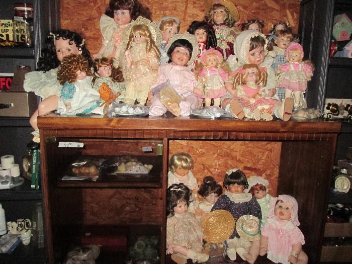 Many porcelain & bisque dolls