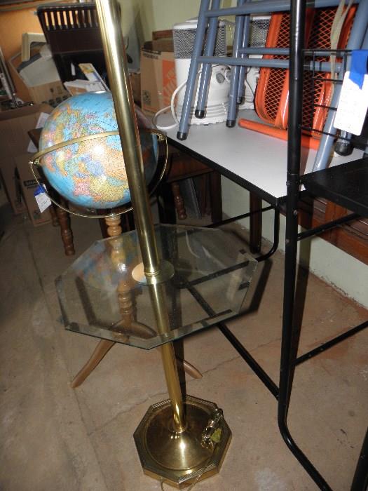globe on stand, floor lamp, metal desk, card table with two folding chairs
