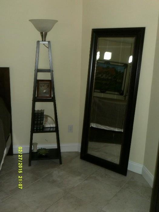 triangle shelf with attached light and very large mirror