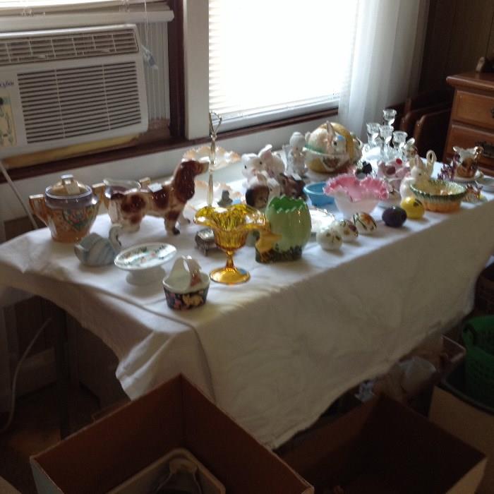 a lot of small figurines and teapot and dishes.