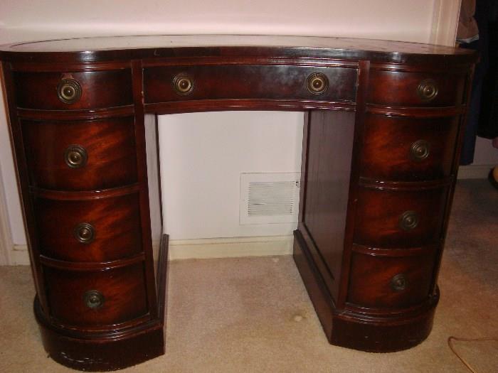 Mahogany leather top kidney shaped desk.