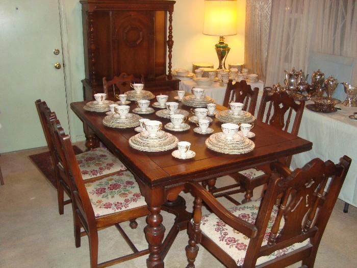 Oak refractory table, six chairs and china cabinet.  Royal Crown Derby "Vine" dinnerware (95 pieces).