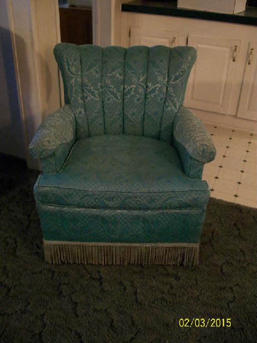 old upholstered chair with fringe