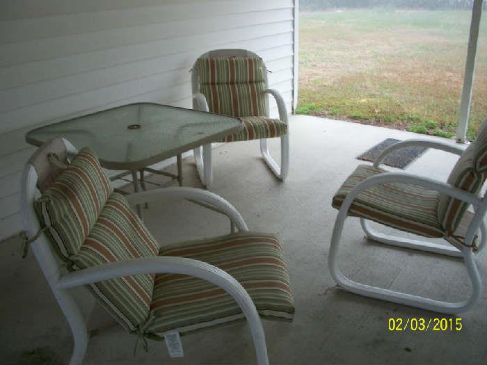 Patio table with 3 chairs showing