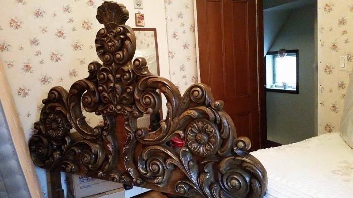 Ornately carved wooden head board. (Queen sized)