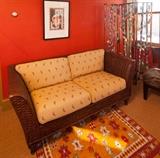 Dark brown natural wood Rattan settee, 73.5 longx36" deep. Upholstered cushions are ivory colored with small parrot design. Folding metal(copper) screen painted to resemble birch trees with bendable leaves.