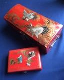 Two Asian boxes of red leather with painted designs on top