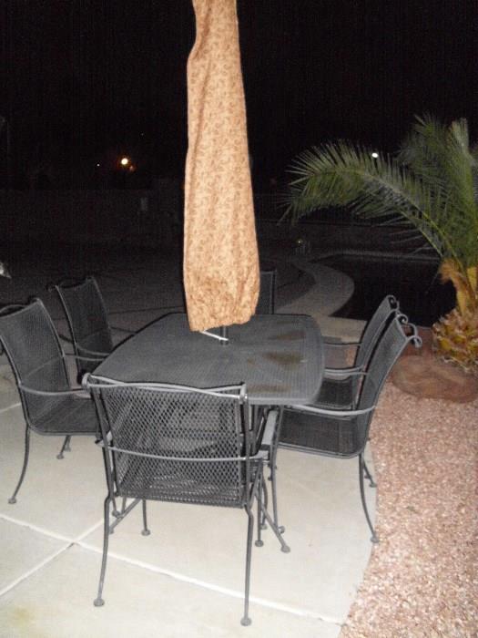 wrought iron patio table and 6 chairs, includes umbrella and stand, also table and umbrella cover!