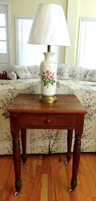 Primitive side table that is large enough to hold a lamp but yet small enough to enjoy as a side table.  Castors make it easy to move and enjoy in any room.