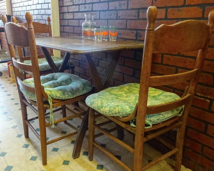 small folding table and pressed back chairs.
