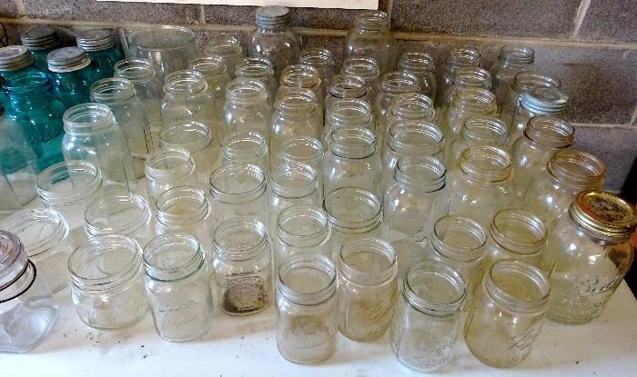 Assortment of styles and sizes in a huge collection of mason jars. Some are very collectable,  and some are blue. 