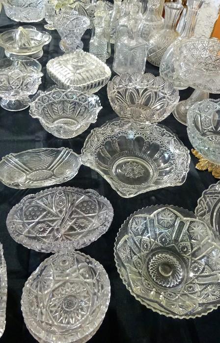 Assortment of clear glass bowls, decanters, serving pieces, candy dishes, cake plates, round platers and so much more.  This collection carries some very classic designs.