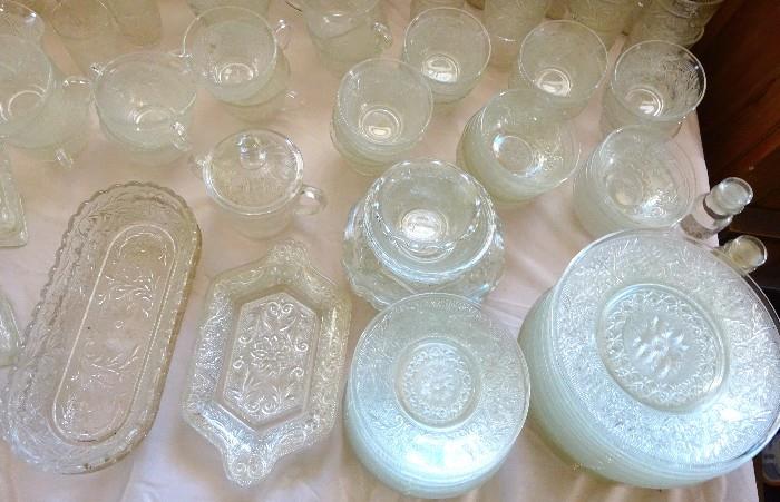 Variety of glassware showing relish trays, sugar & creamer dishes, candle holders, plates with matching cups and much more. Beautiful pieces.