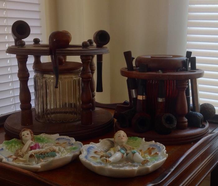 Assortment of vintage pipes, tobacco decantors, and stand. Many different sytles of pipes to choose from in this collections.