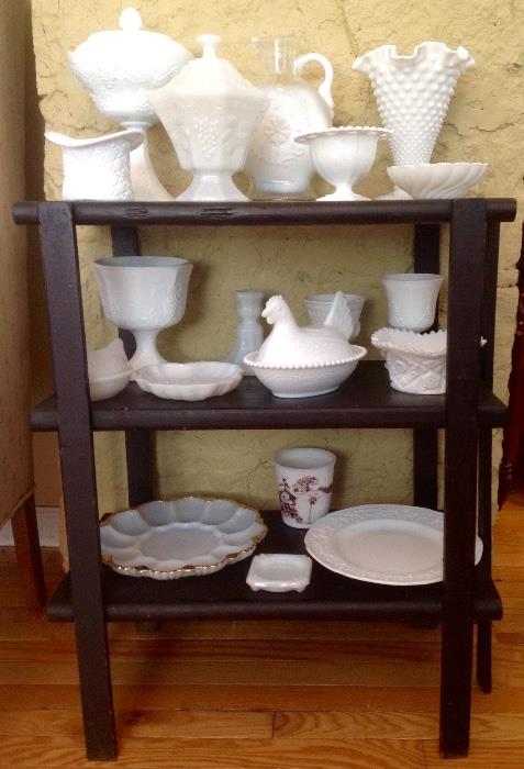 A collection of milk glass from kitchen to bathroom to bedroom.  All items are in good shape sitting on a handmade three shelf bookcase.  