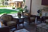 Wicker patio set six chairs ,two with matching ottomans, three-seat sofa, glass-top wicker tables.Priced separately.