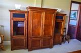 Three pieces for electronic equipment ,television cabine, two side glass front cabinets . Sold separately ,shows tall TV cabinet and shorter electronic cabinets. All same wood tone.