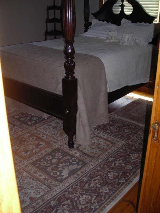 four poster bed and another rug