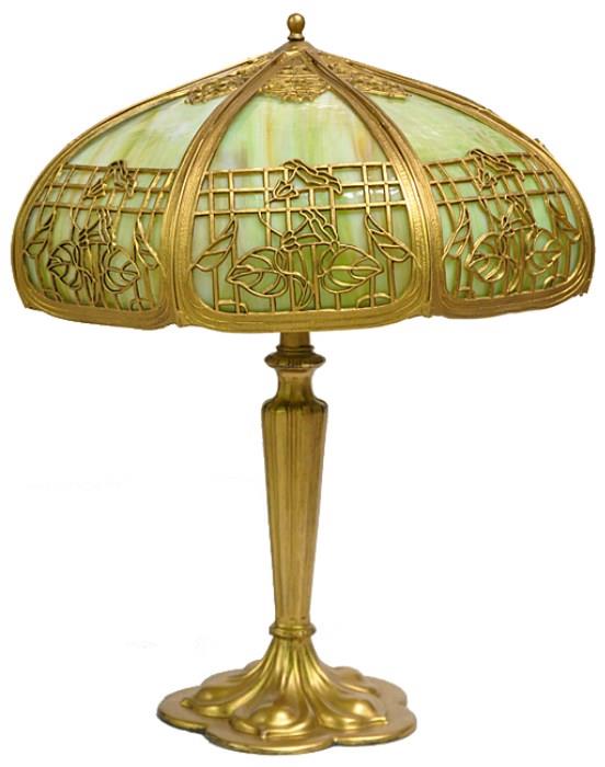 ANTQ. SLAG GLASS PANEL LAMP. WITH AN ART NOUVEAU STYLE BASE. LAMP MEASURES 22" TALL. SHADE MEASURES 17" IN DIAMETER.