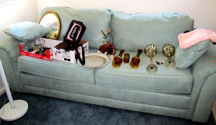 Large Sofa (Seafoam Microfiber) with padded arms and light blue upholstery.  Also shown are some of the colored glass items that are also available.