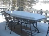Glass topped patio table (with snow) and 6 chairs