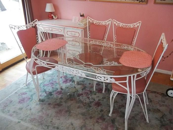 Vintage wrought iron glass top kitchen/patio set with vinyl insert chairs and matching desk/chair.