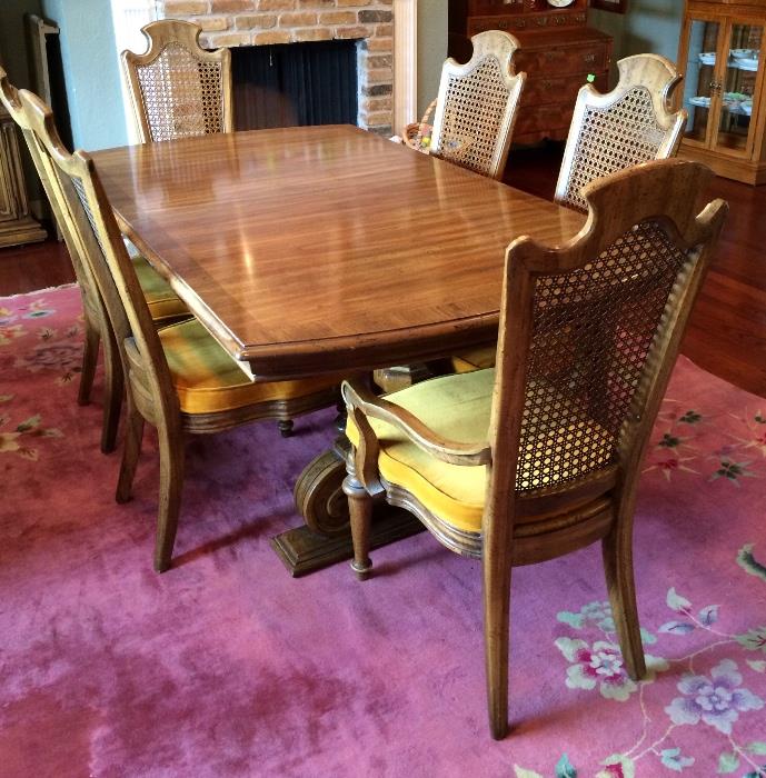 Vintage table with 6 chairs, rose pink rug.