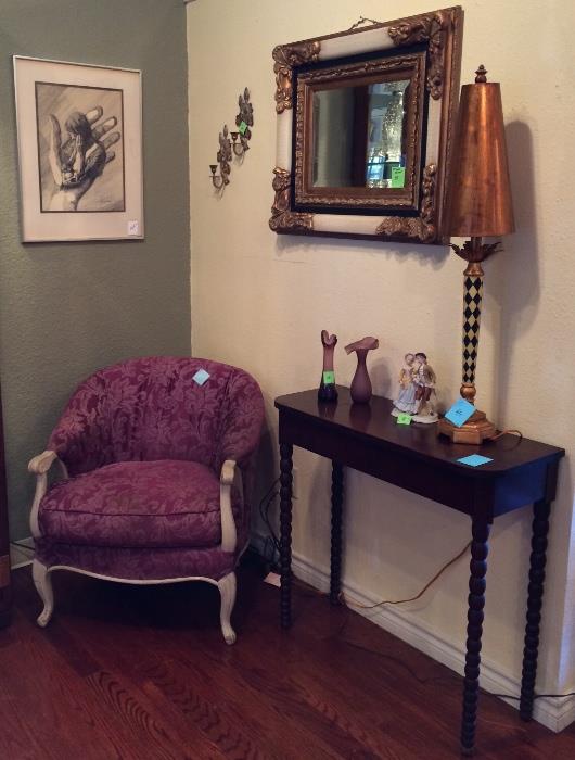 Gorgeous mirror, mahogany foyer table, purple easy chair, lamps, purple vases, art.