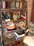 Marble shelved bakers rack. Copper, ceramic pieces, coffee table books