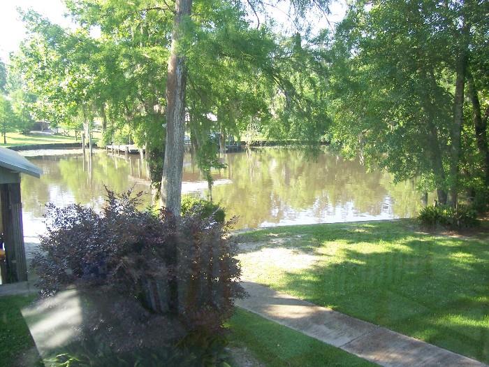 Look at this great river view from the back yard -that's why NO CHILDREN are allowed at this sale.  Too many stairs, balconies, and breakables.
