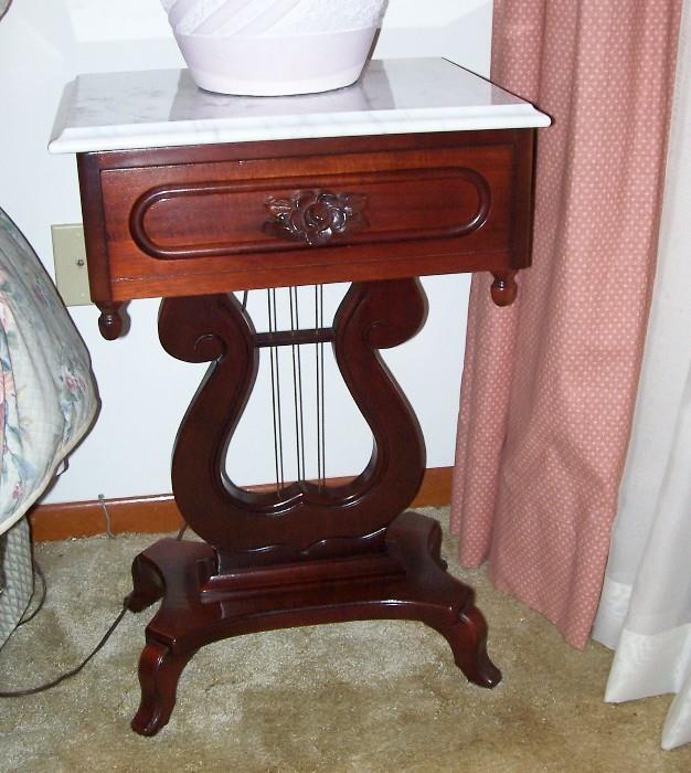 Bedside table with a lyre base....