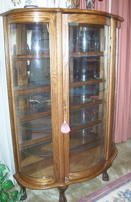Nice curved glass china cabinet with glass shelves and mirrored back