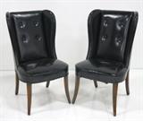 Lot #563 Black leather wingback chairs