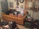 Retro sleeper-sofa, vintage floor lamp, file cabinet, Nikon camera and lenses