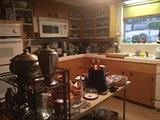 Kitchen full of dishes, glasses, cookware - note the pewter in the foreground