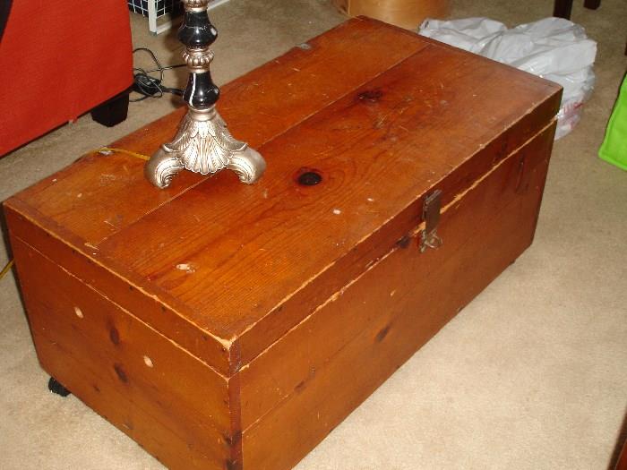Wooden chest.  used as coffee table with wheels, also a glass top to place on top if needed.