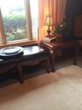    Carved wood/leather bed bench; end table; one of many lamps