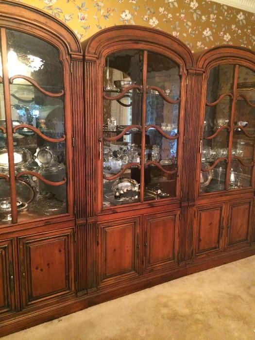     Extra large 3 lighted china cabinets/wall units filled with silver/silver plate serving pieces