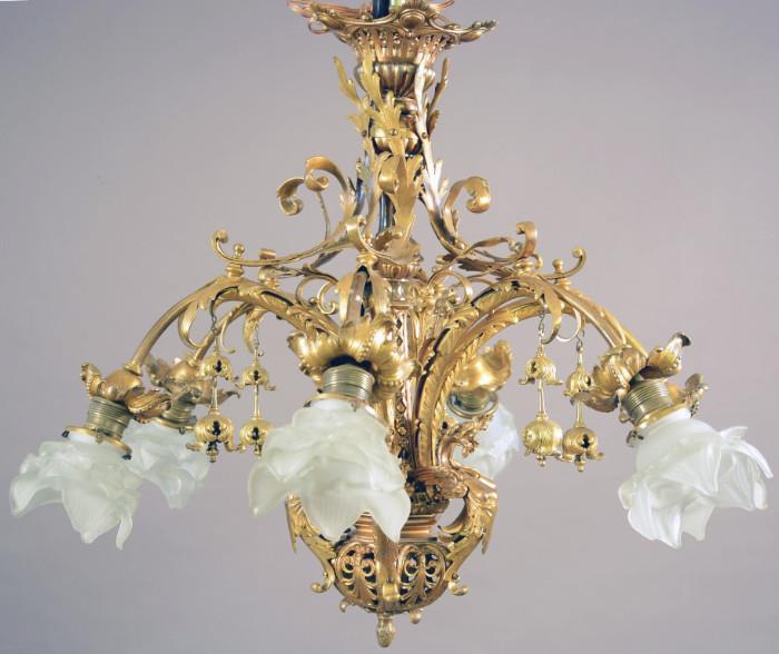 French Louis XV style fancy bronze, six arm, chandelier. Leaf decorated center with six gargoyles. ca. 1900. 24" t x 28" w