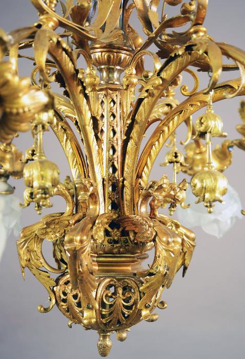 French Louis XV style fancy bronze, six arm, chandelier. Leaf decorated center with six gargoyles. ca. 1900. 24" t x 28" w