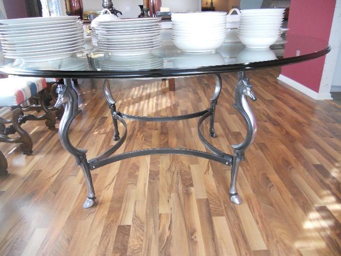 Round glass top dining table with horse heads