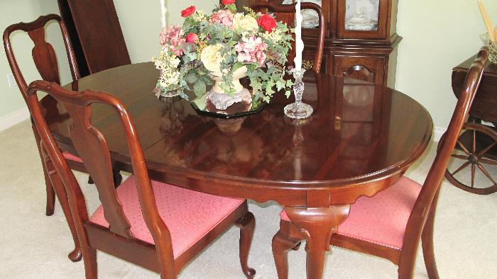 Ethan Allen cherry table with six chairs and two wide leaves, mint condition.