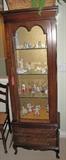Narrow cherry display cabinet.