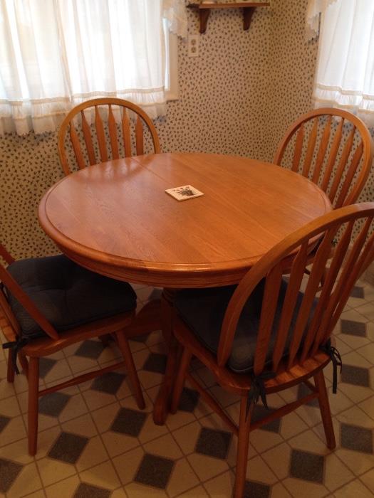 Solid Oak pedestal table with 4 chairs and leaf from Ten Penny Furniture. Leaf is approx. 18" wide and not in picture.